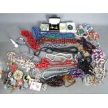 A quantity of costume jewellery to include necklaces, brooches, rings, earrings and similar,