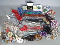 A quantity of costume jewellery to include necklaces, brooches, rings, earrings and similar,