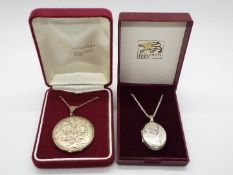 Silver Jewellery - Two silver locket pendants with engraved decoration on silver chains,