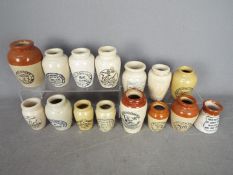 A collection of antique and later stoneware jars, cream, Virol and similar.