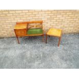 A telephone table incorporating green upholstered seat,