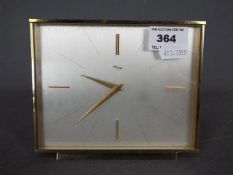 An Imhof brass cased desk clock, approximately 12 cm x 15 cm.