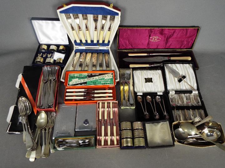 A quantity of plated and stainless flatware including cased and boxed sets,