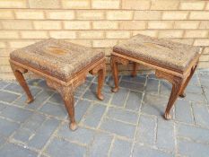 A pair of intricately carved Indian side tables measuring approximately 41 cm x 49 cm x 35 cm.