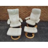 Two Ekornes Stressless lounge chairs and matching footstools.