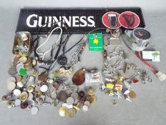 A mixed lot to include a Guinness bar mat, Japanese dashboard clock, coins, costume jewellery,