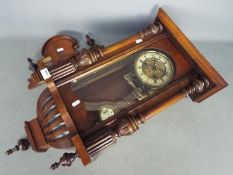 A Vienna styled wall clock, the case having turned and carved decoration,