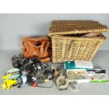 Lot to include a basket containing fishing equipment, reels and similar.