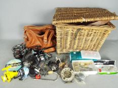 Lot to include a basket containing fishing equipment, reels and similar.