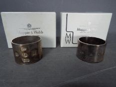 Two boxed Mappin & Webb hallmarked silver napkin rings, one Sheffield assay, the other Birmingham,