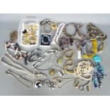 A collection of costume jewellery to include brooches, paired earrings, necklaces,