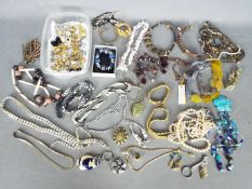 A collection of costume jewellery to include brooches, paired earrings, necklaces,