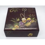 A varnished wooden box, finely hand painted to the cover with a basket of pansies,