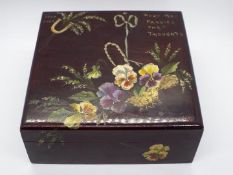 A varnished wooden box, finely hand painted to the cover with a basket of pansies,