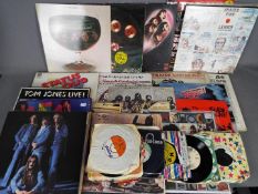 A collection of vinyl records 7" and 12" to include Deep Purple, The Rolling Stones, John Lennon,