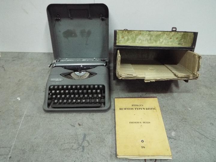 Pitmans Swiss Typewriter with Hellioue typewriting course book. Vintage. Case is 33cm wide.