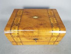 An inlaid, dome top writing slope, with key, approximately 15 cm x 30 cm x 21 cm.