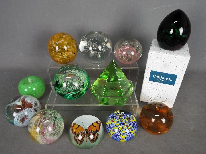 A collection of paperweights to include Caithness, Mdina, Selkirk Glass, Odessa and similar.