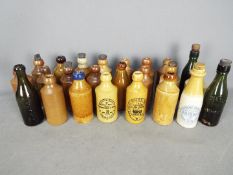 A collection of antique glass and stoneware ginger beer and similar bottles to include Brownson's
