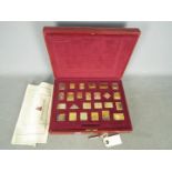 A silver gilt replica stamp set The Empire Collection,