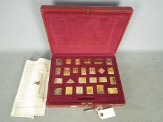 A silver gilt replica stamp set The Empire Collection,