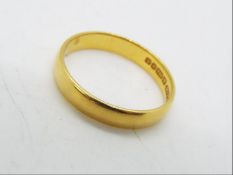 A 22ct gold wedding band, size P, approximately 3.4 grams all in.