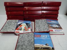 A travel bag containing a large quantity of Flight Check magazine, contained in binders.