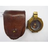 A British military brass compass scribed with crow's foot and leather case Lot descriptions