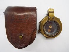 A British military brass compass scribed with crow's foot and leather case Lot descriptions