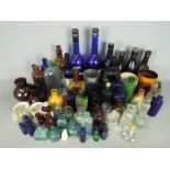 A collection of antique and later bottles including poison, Bovril, hair restorer and similar,