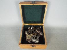 A boxed brass sextant.