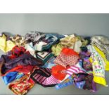 A collection of silk and similar scarves.