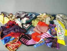 A collection of silk and similar scarves.