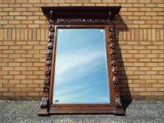 A very large Victorian oak framed bevel edged mirror,with carved detail throughout,