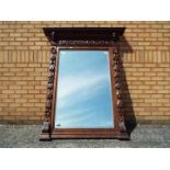 A very large Victorian oak framed bevel edged mirror,with carved detail throughout,