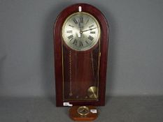 A modern mahogany cased wall clock, Roman numerals to a silvered dial,