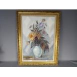 A framed oil on canvas still life, signed lower right by the artist, approximately 69 cm x 48 cm.