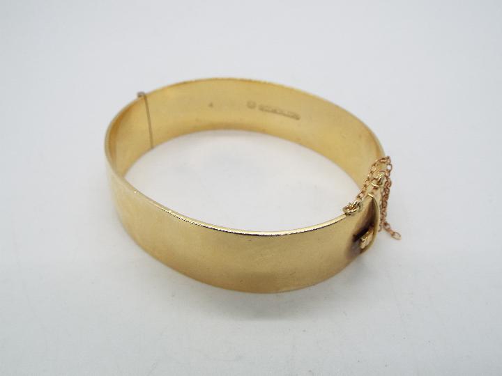 A 9ct metal core hinged bangle with engraved foliate decoration (44 grams all in), - Image 4 of 5