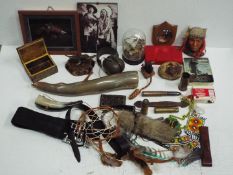 A mixed lot of collectables to include horns, Native American themed items, ear defenders,