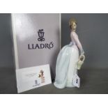 Lladro - A boxed figurine entitled Basket Of Love, # 7622, approximately 25 cm (h).