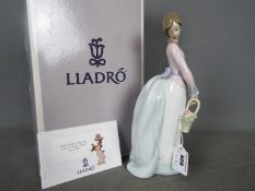 Lladro - A boxed figurine entitled Basket Of Love, # 7622, approximately 25 cm (h).