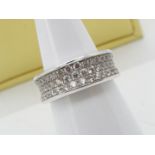 An 18ct white gold and diamond ring by David M Robinson, pave set with 47 stones in three rows,