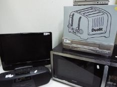 Lot to include a microwave, boxed toaster, video recorder, DVD player and similar.