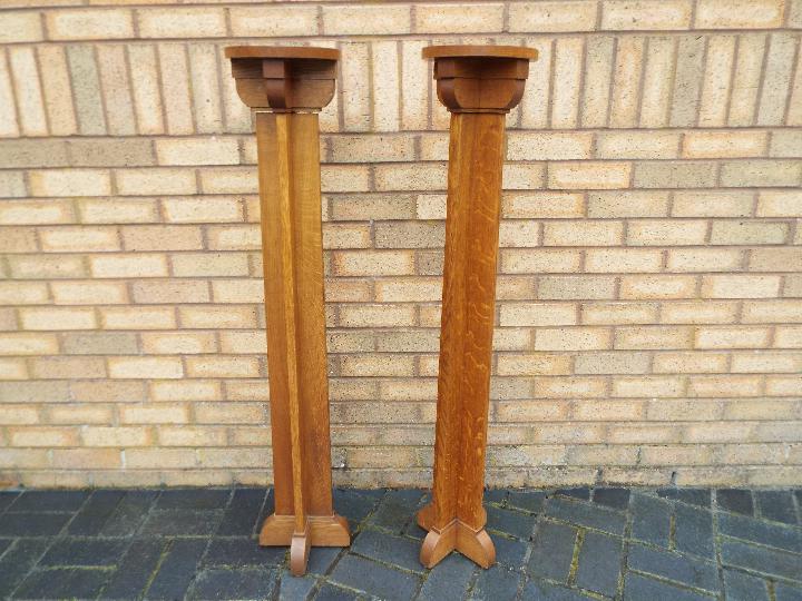 A pair of Gothic revival light oak Arts and Crafts style Torcheres, approx 121.