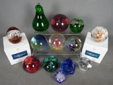 A quantity of paperweights to include Caithness, Perthshire, Selkirk Glass and similar.