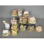A small collection of Lilliput Lane and similar model buildings and a Nao figurine depicting a