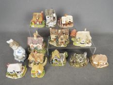 A small collection of Lilliput Lane and similar model buildings and a Nao figurine depicting a