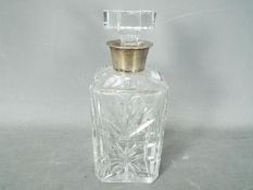 A cut glass decanter with silver mounted neck, Birmingham assay,