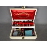 A jewellery box containing a quantity of costume jewellery, rings, necklaces, earrings, beads,