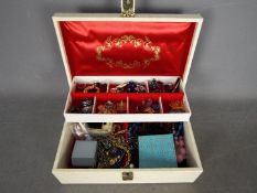 A jewellery box containing a quantity of costume jewellery, rings, necklaces, earrings, beads,